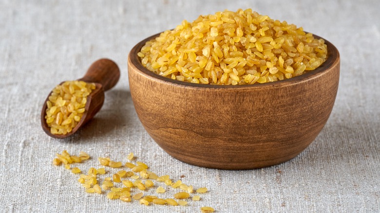 Uncooked bulgur in a wooden bowl