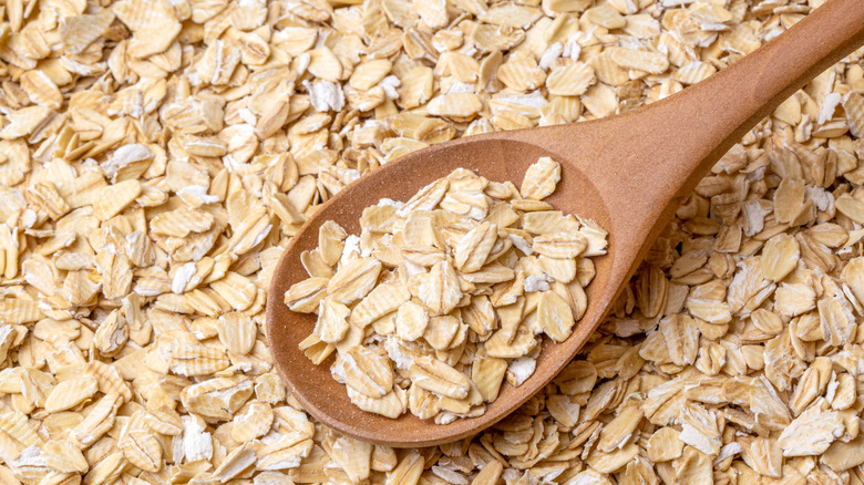 A wooden spoon in rolled oats