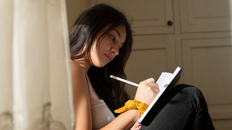 Woman writing in a journal