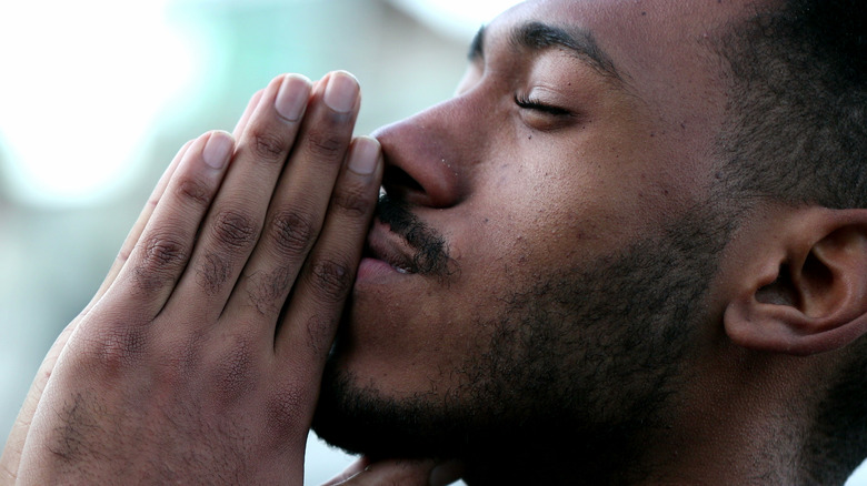 Man meditating with blurred background