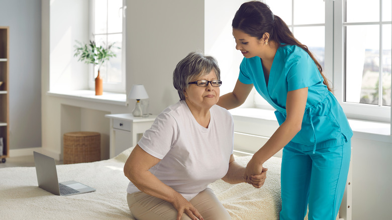 Healthcare worker assisting woman