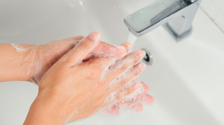 Washing hands with soup and water