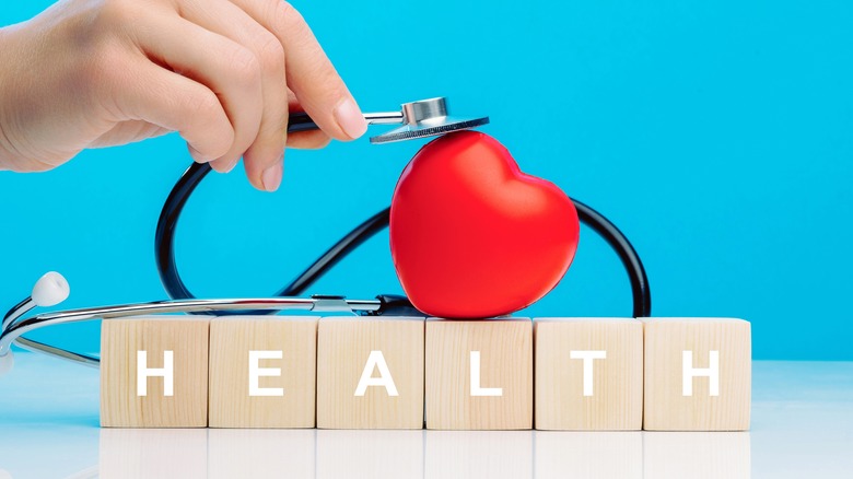 Heart and stethoscope on top of blocks that spell out "health"