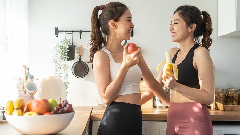 Two friends snacking together at home