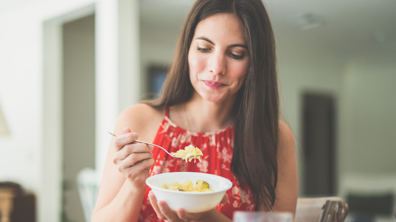 Woman eating a snack at her table