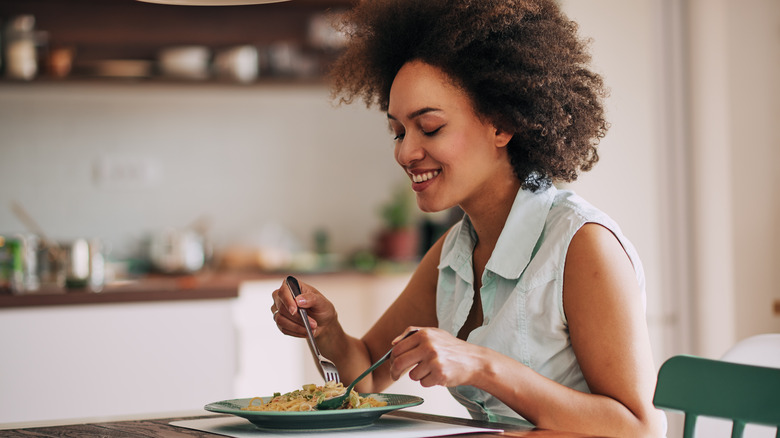 Woman eating dinner at her table