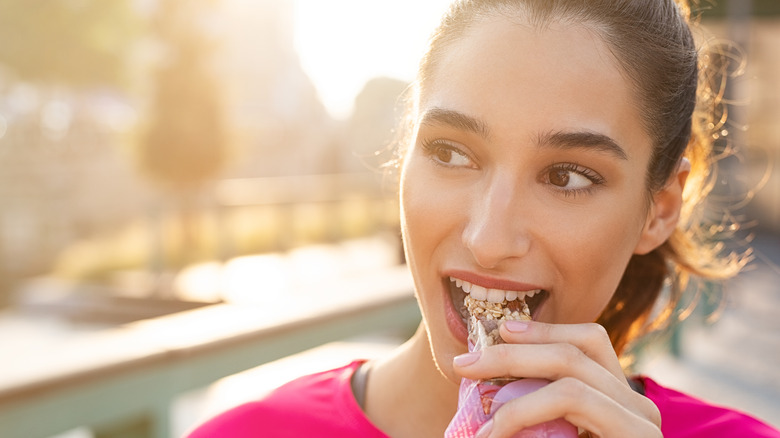 Woman eating a protein bar