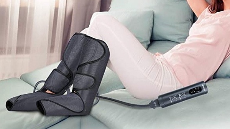 A woman wearing leg massagers