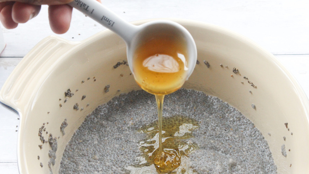 Honey being poured into bowl of chia seeds