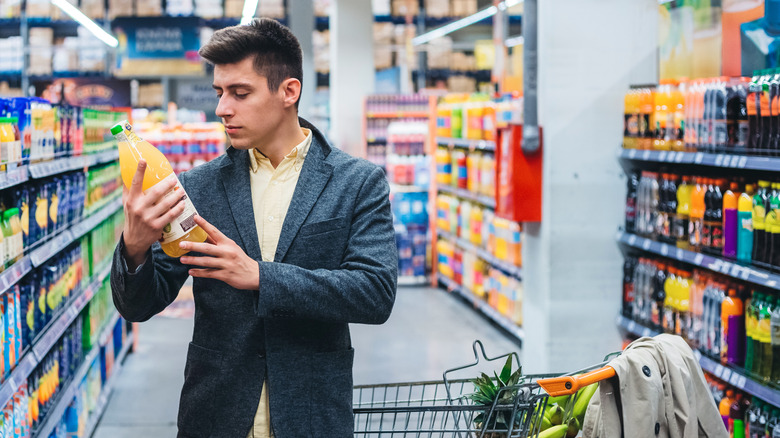 Man shopping in beverage aisle at store