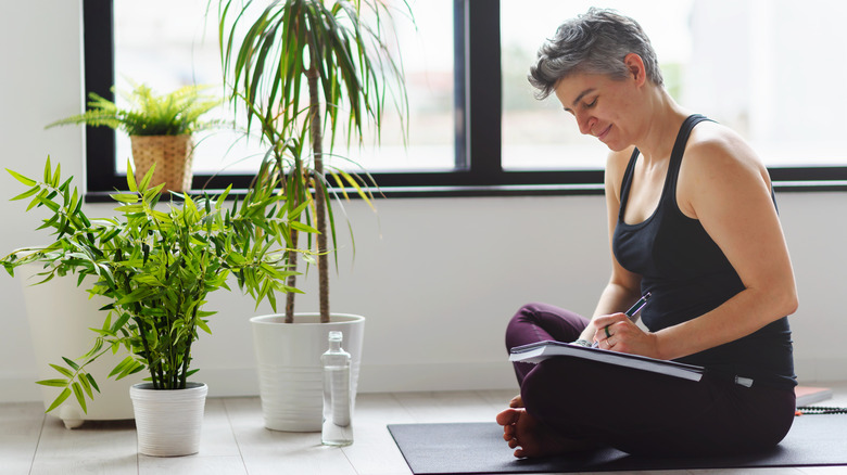 Smiling woman writing in journal