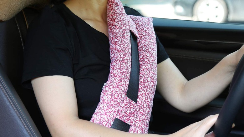 Driver wearing seatbelt pillow