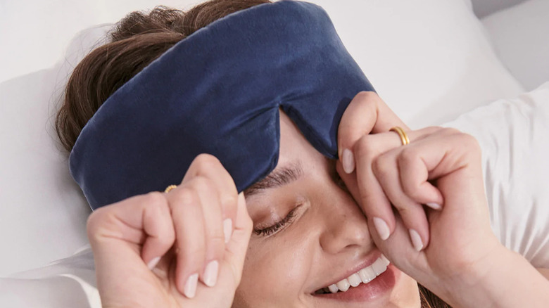 Smiling woman wearing sleep mask