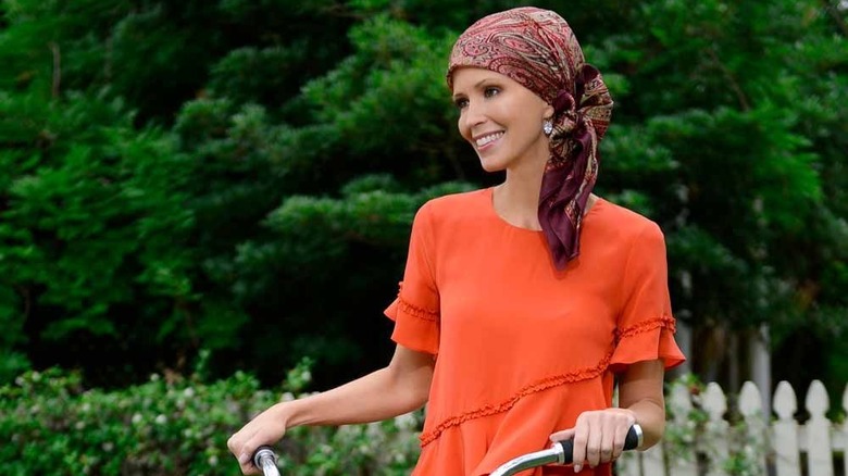 Smiling woman with headscarf on bike