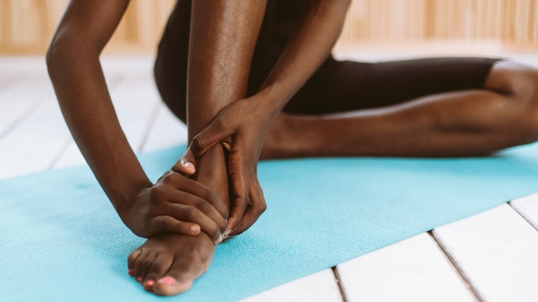 Stretching feet on yoga mat