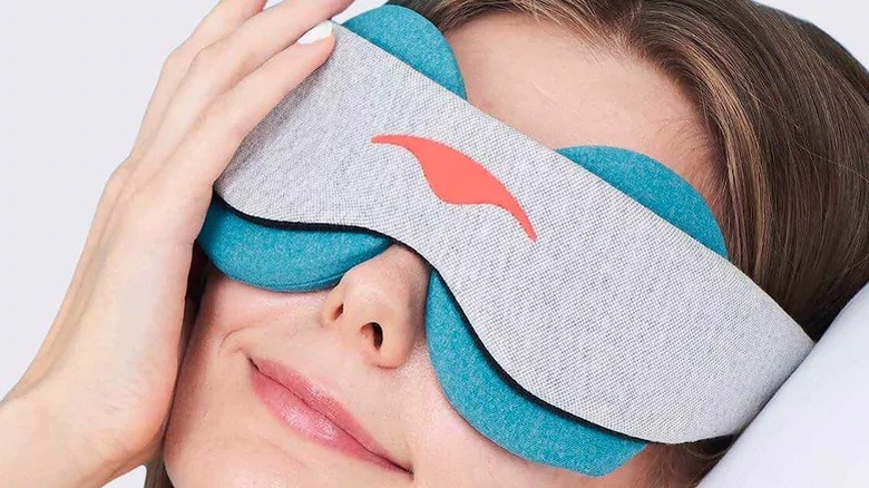 A woman wearing an eye mask