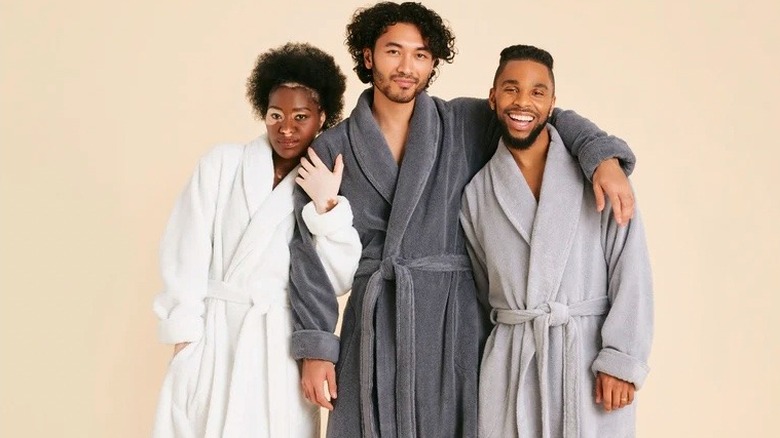 Three people wearing robes