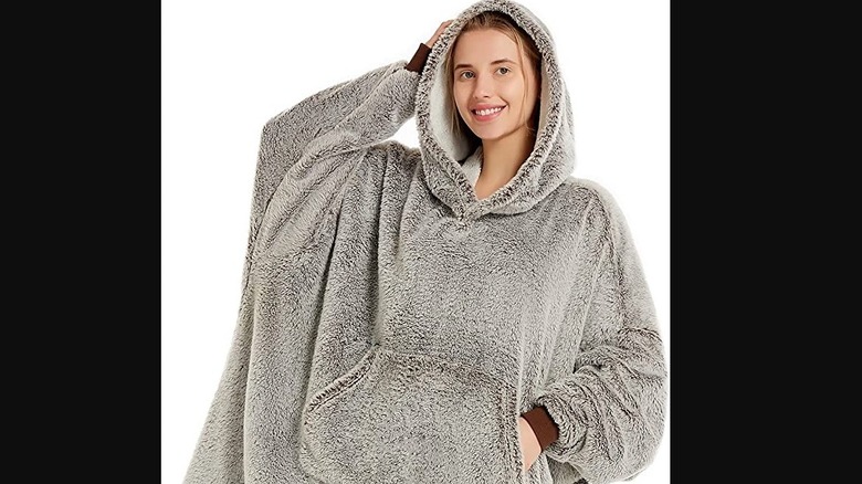 A woman wearing a hooded blanket