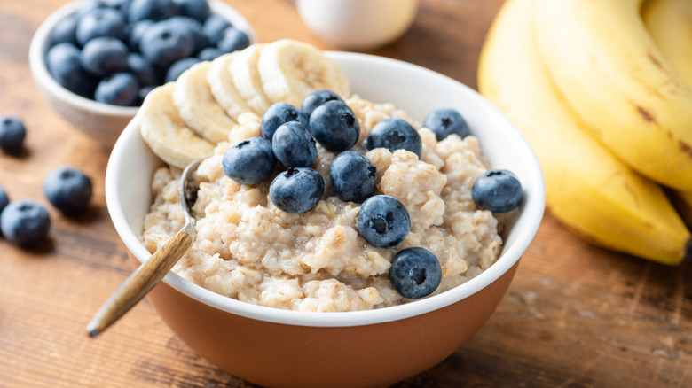 A bowl of oatmeal topped with blueberries