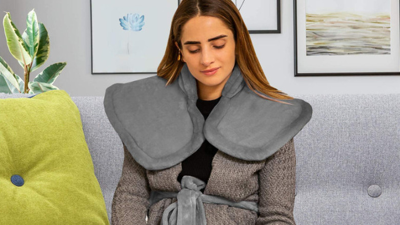Woman wearing gray heating pad