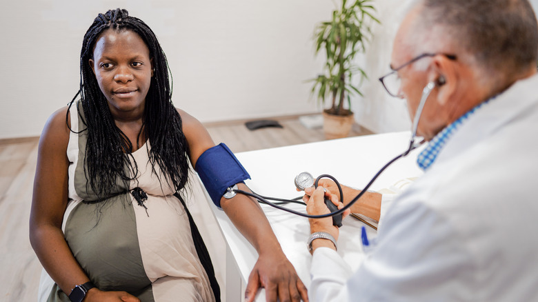 pregnant woman getting her blood pressure checked