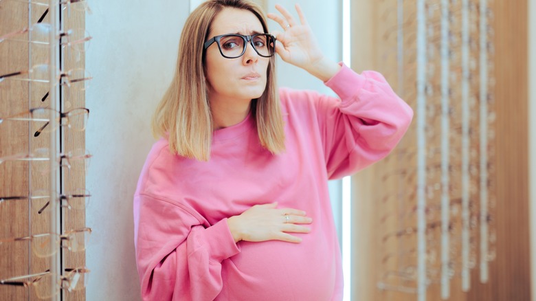 pregnant woman questioning her eyeglasses
