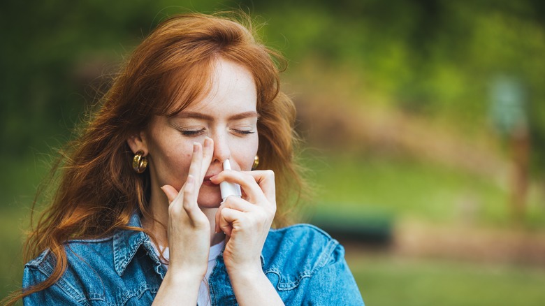 woman using a nasal spray