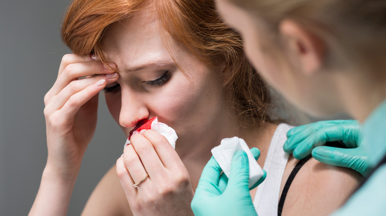 Nurse treating a nosebleed