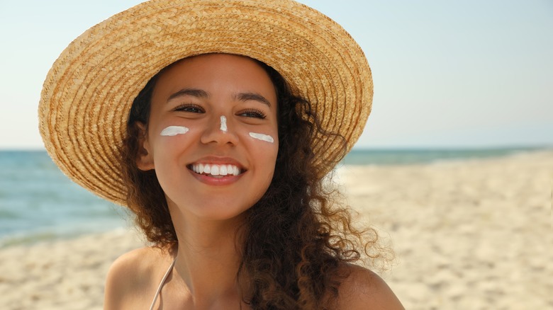 Woman wearing sunscreen and hat