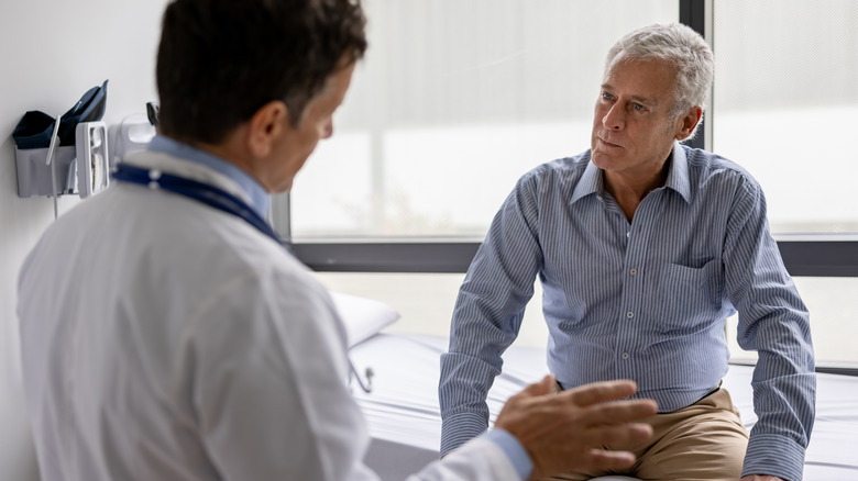 man listening to doctor