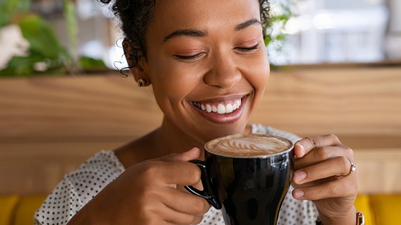 young woman ready to enjoy fresh cup of coffee