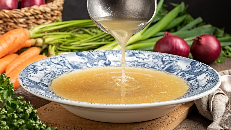 Fresh bone broth being ladled out