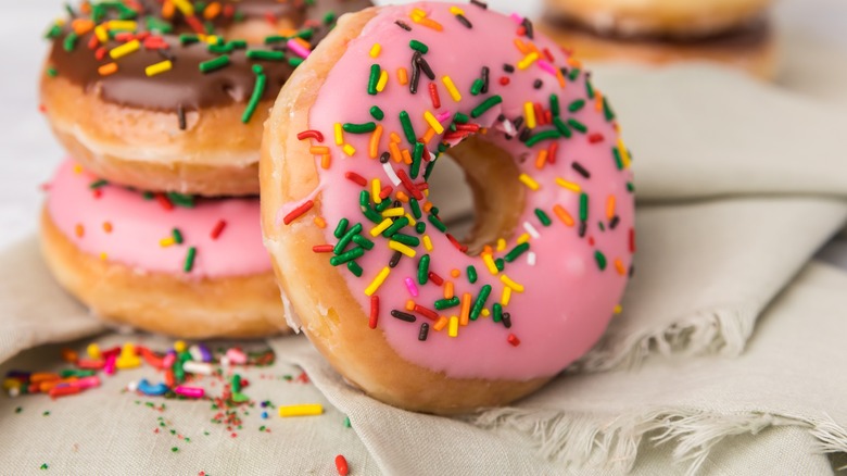 three donuts with frosting and sprinkles