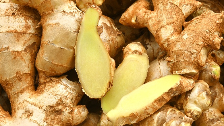 a pile of ginger root with fresh slices