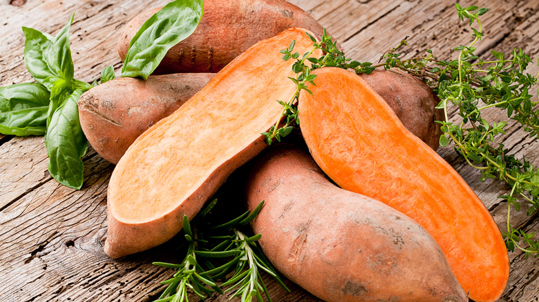 sweet potatoes positioned on a wooden board