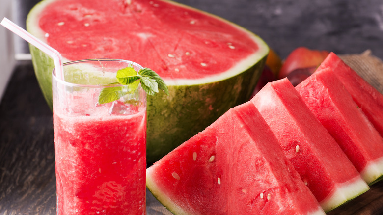 slices of watermelon aside a glass of watermelon juice