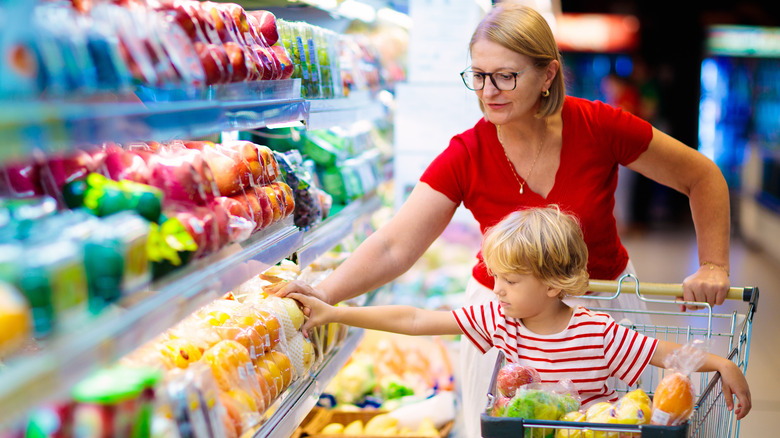 mother and son with grocery cart