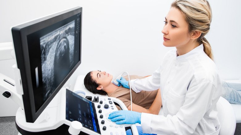 doctor checking ultrasound of thyroid gland