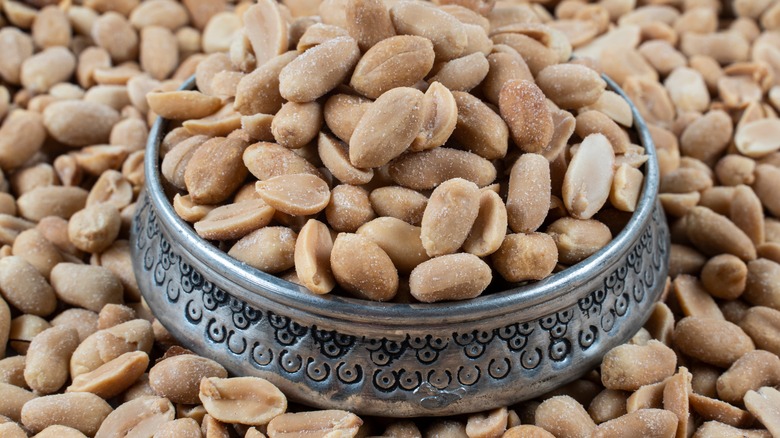 peanuts overflowing in silver bowl