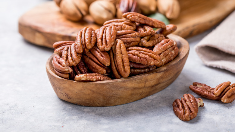 pile of pecans in wooden bowl