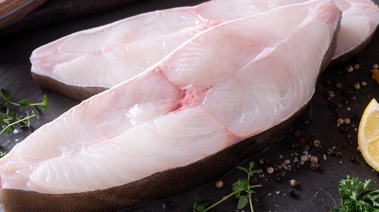 Raw halibut steaks on table