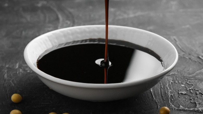 Pouring soy sauce in bowl