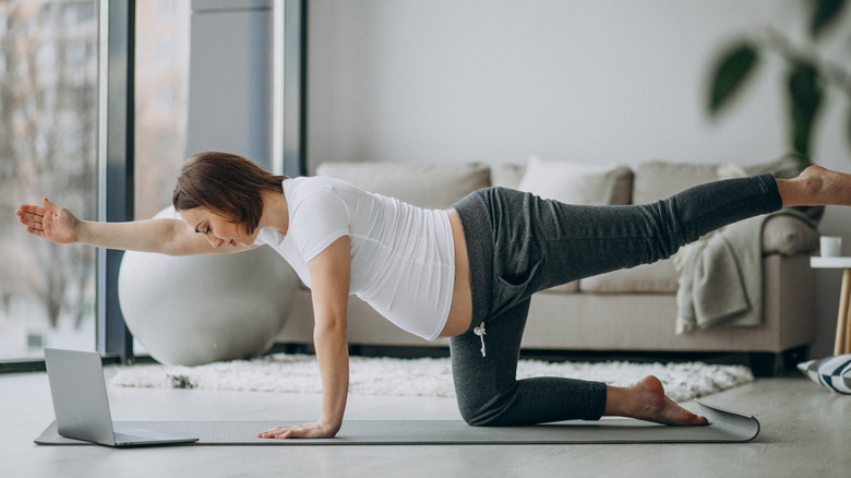 pregnant woman doing bird dog