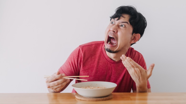 man eating spicy food