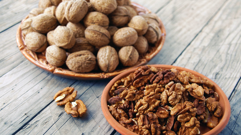 Bowls of shelled and unshelled walnuts