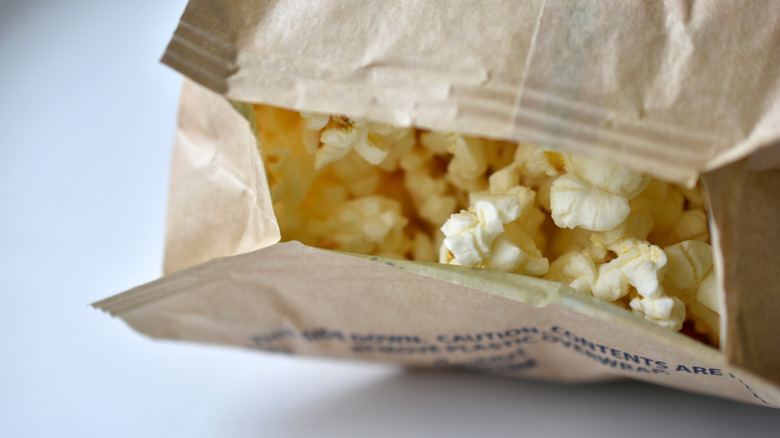Close up of the opening of a bag of microwave popcorn