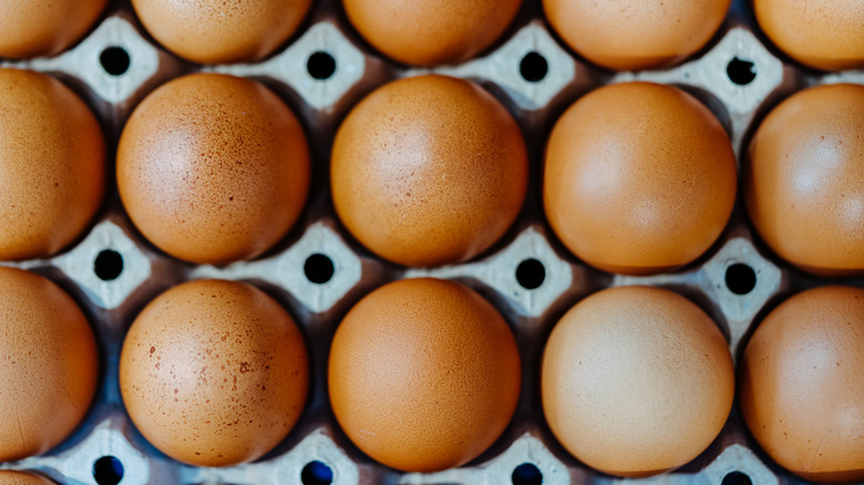 Overhead shot of brown eggs in an egg crate