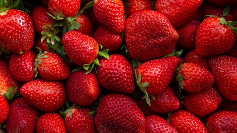 Overhead shot of a bunch of red strawberries piled on top of one another