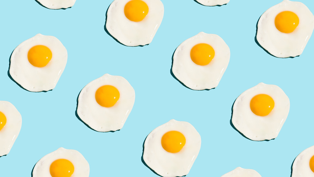 Sunny-side up eggs on a blue table