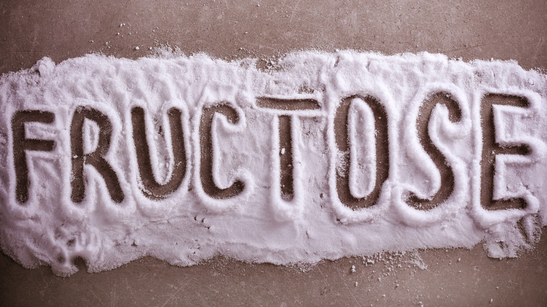 The word fructose written in white powder 